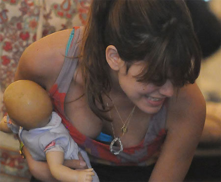 Here are some pictures of Rachel Bilson's tits holding a doll like she's